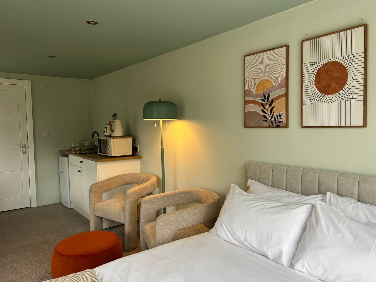 Studio room with kitchenette and framed prints