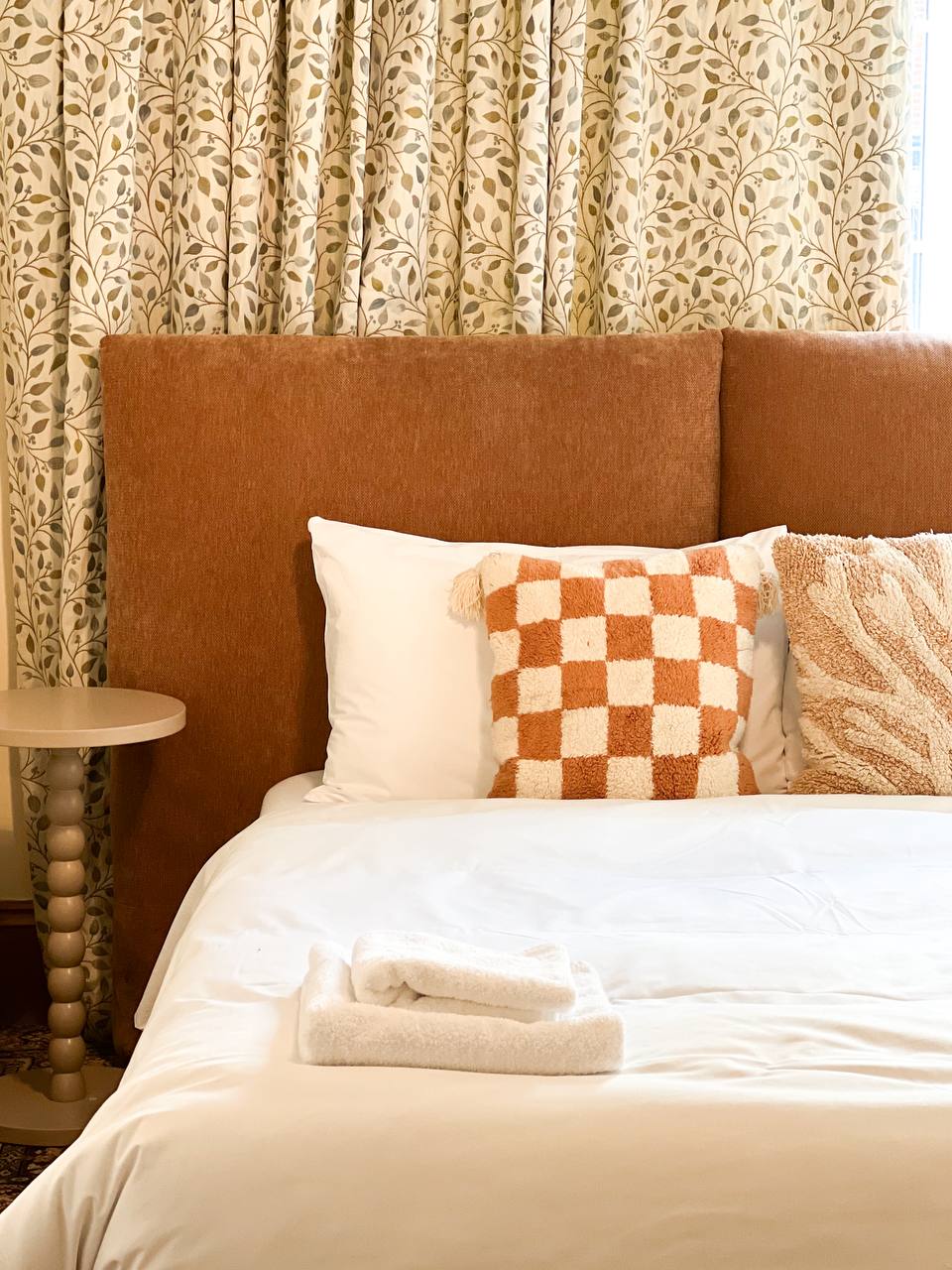 Terracotta headboard with patterned curtains